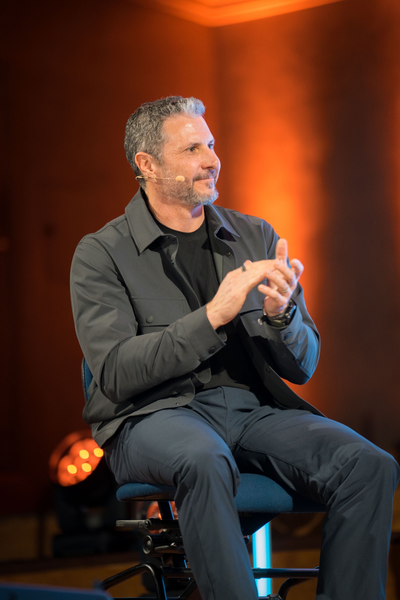 Eric Malzone seated on stage during a kickoff event