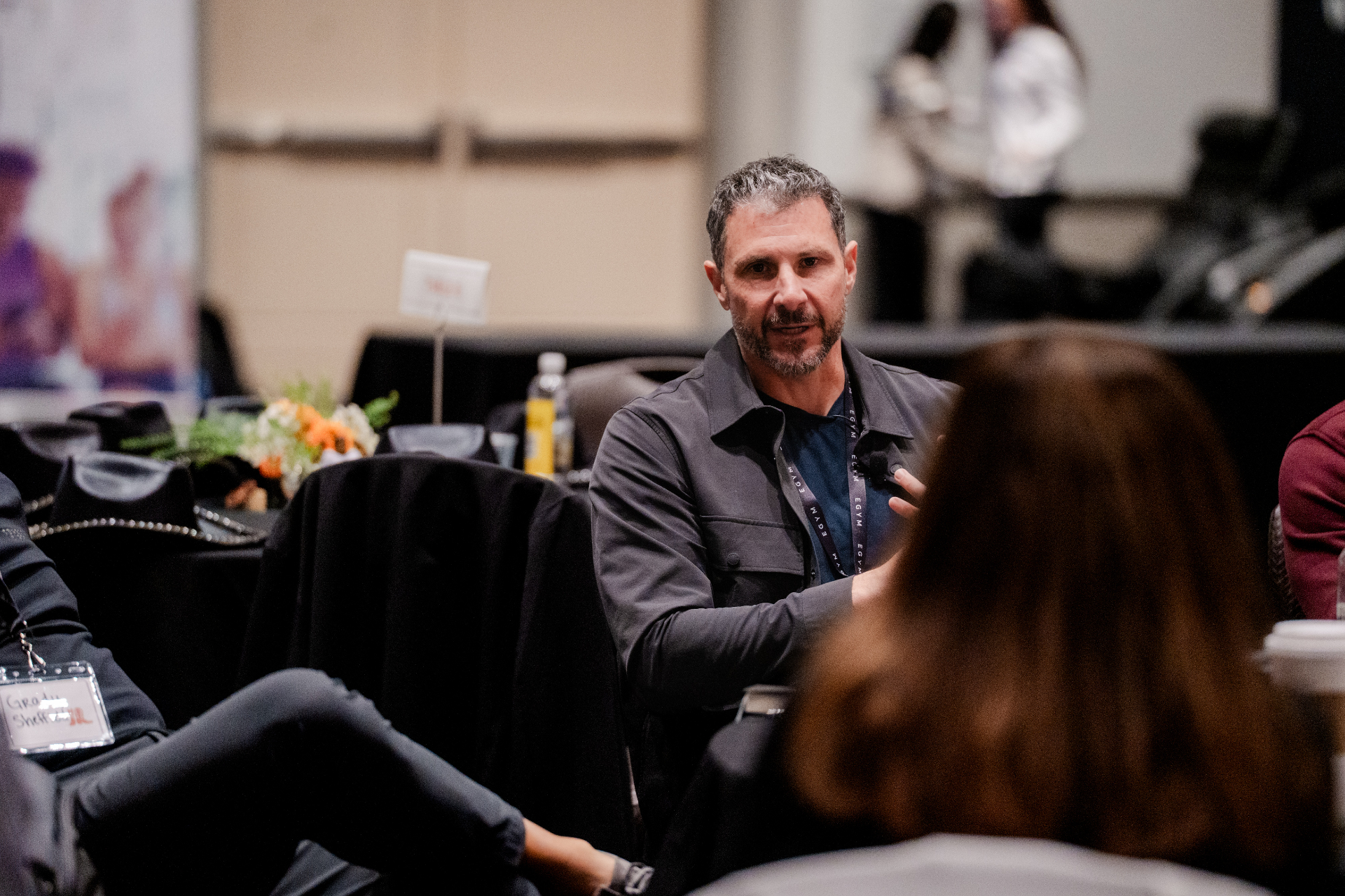 Eric Malzone in conversation with an industry leader at a fitness conference